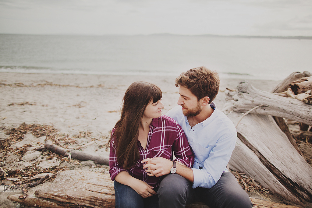 Engagement session at Discovery Park, Seattle. Beautiful lighthouse on background