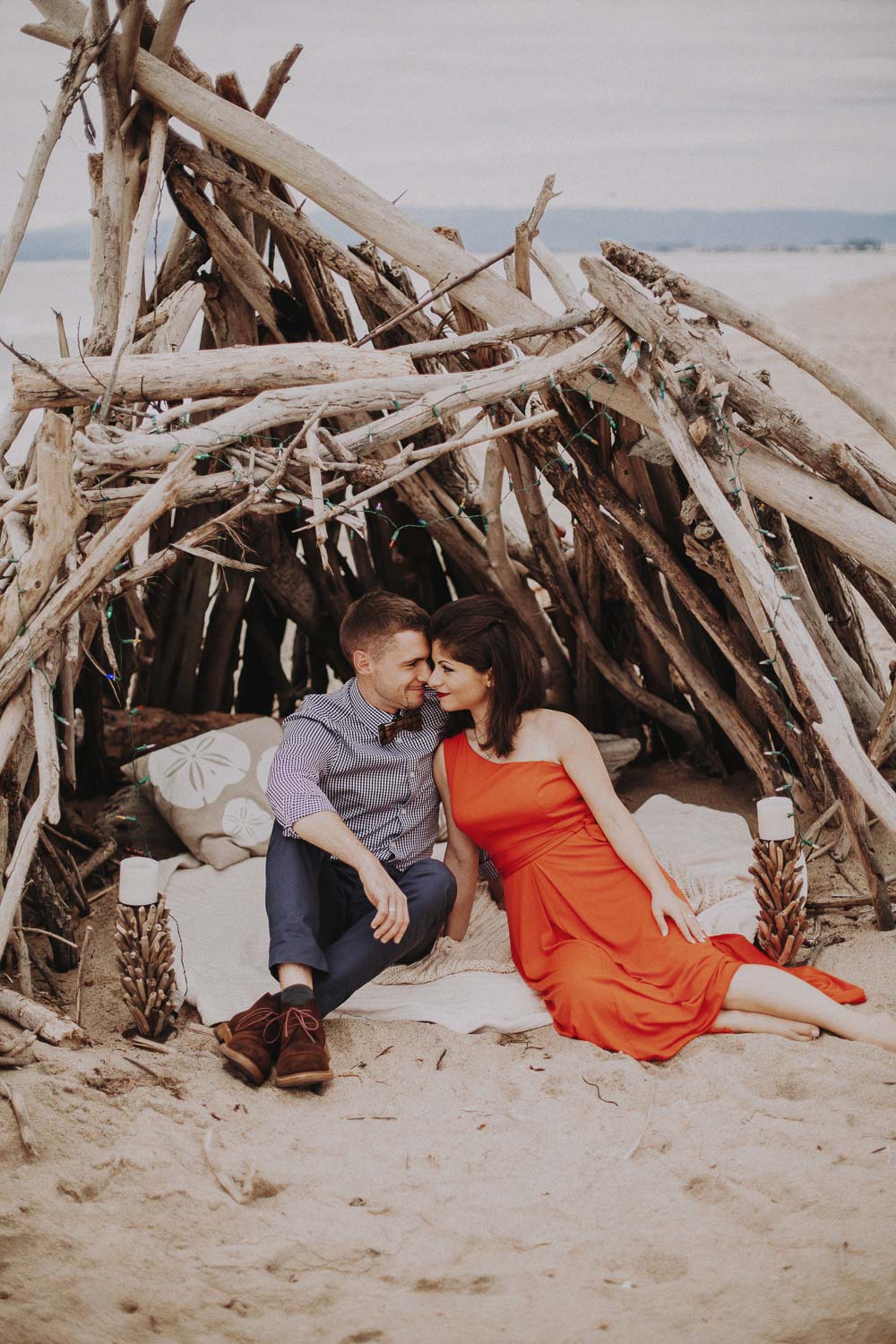 Monterey moody cloudy beach engagement session. California ocean engagement session in red dress