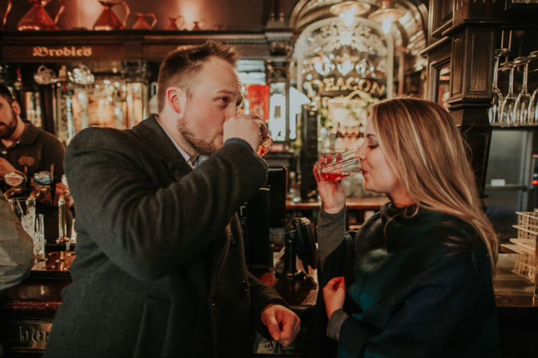 Moody destination spring engagement session in Old Town of Edinburgh, Scotland. Rainy engagement in Deacon Brodie's Tavern by destination photographer