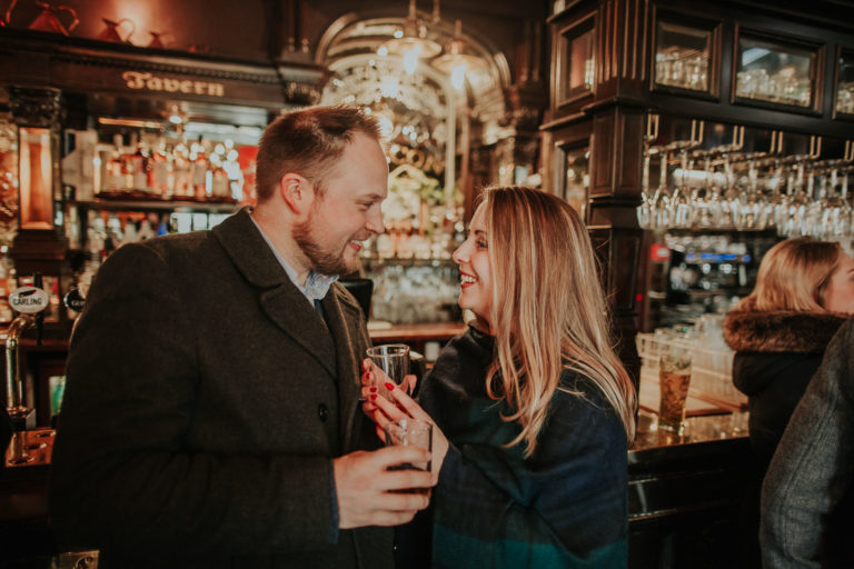 Moody destination spring engagement session in Old Town of Edinburgh, Scotland. Rainy engagement in Deacon Brodie's Tavern by destination photographer